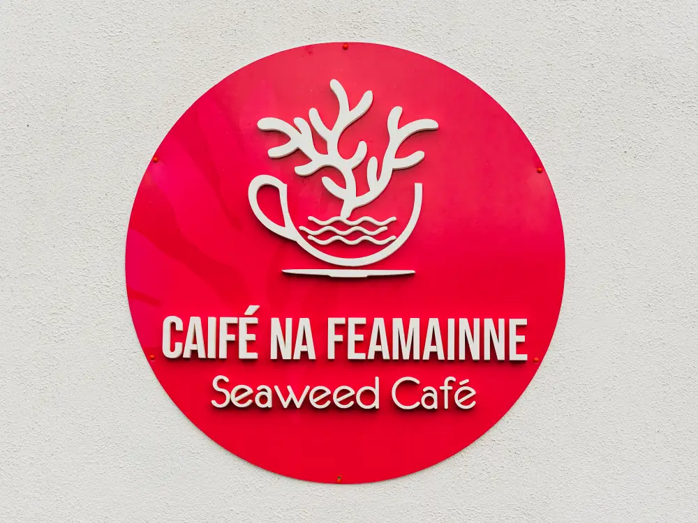 Red sign with Seaweed Cafe logo on wall